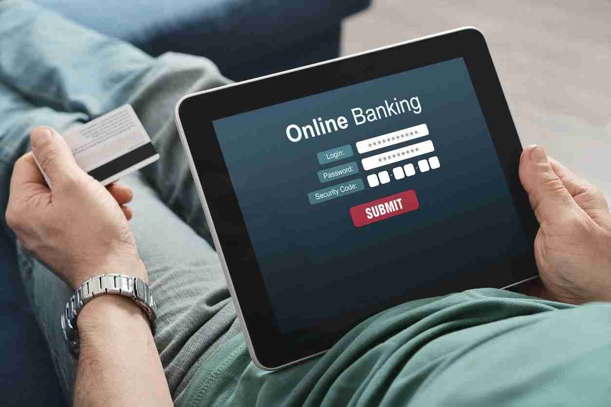 Person using a tablet for online banking, about to submit their login credentials.